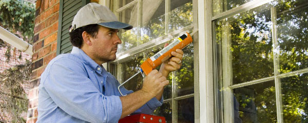 Man Caulking Window Man Caulking Window