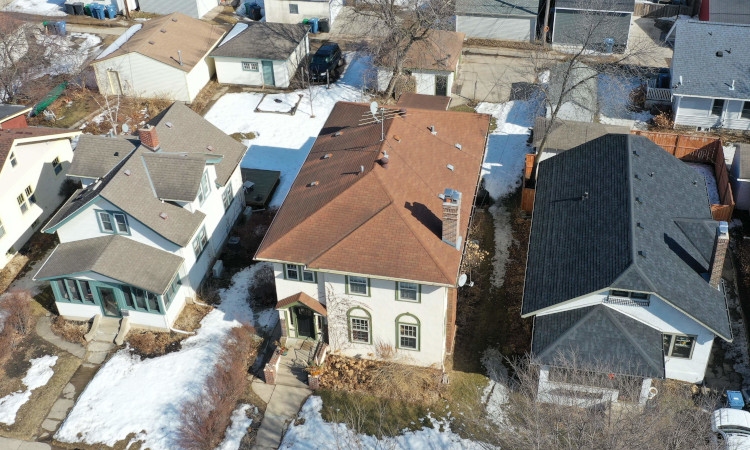 Drone performing aerial roof inspection.