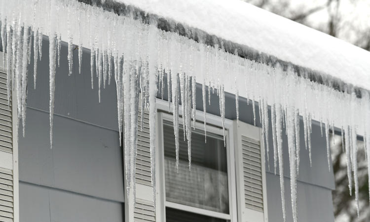icicle on the house roof in winter season