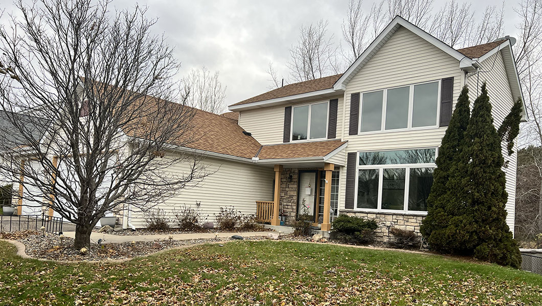 Outside of a residential home with large white triple-pane windows