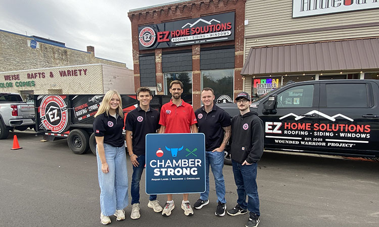 EZ Home Solutions staff standing in front of their office and vehicles